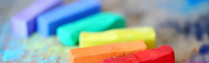 Mehrere bunte Kreidestücke liegen auf einem Tisch